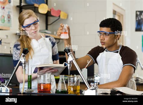 High school students conducting experiment in chemistry class Stock Photo - Alamy