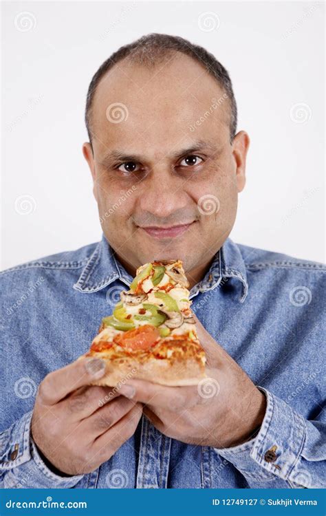 Guy eating pizza slice stock image. Image of cheese, worker - 12749127