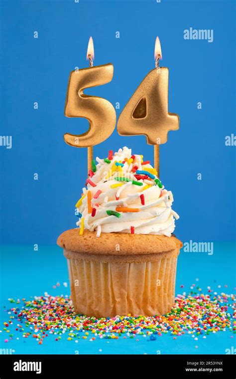 Birthday cake with candle number 54 - Blue background Stock Photo - Alamy