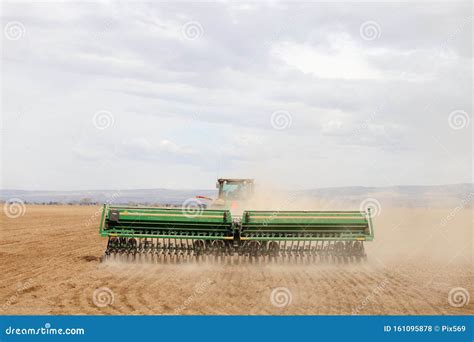 A Farmer in a Tractor Planting Wheat. Stock Photo - Image of ...