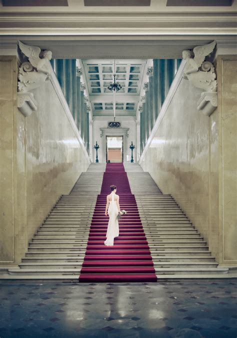 Bride in crepe column gown ascends red carpet up marble stairs - Studio ...