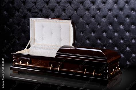 Opened wooden brown sarcophagus isolated on gray luxury background. casket, coffin on royal ...