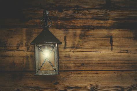 Black Metal Candle Lantern Hanging on Wood Wall · Free Stock Photo