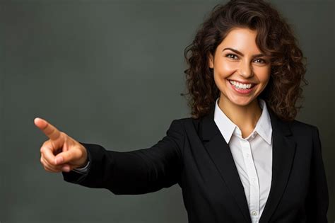 Premium AI Image | a woman in a suit pointing to the camera with a dark green background