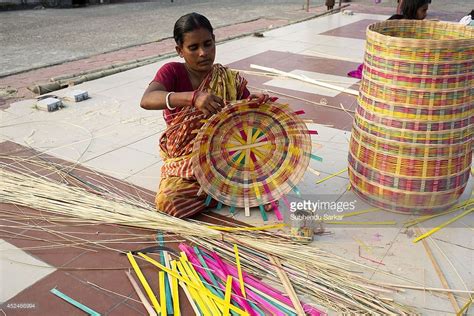 A woman engaged in making handicraft products with cane. Handicraft ...