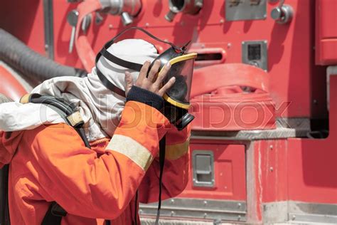 Firefighter wearing mask safety suite ... | Stock image | Colourbox