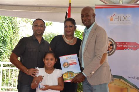 Prime Minister Dr. the Hon. Keith Rowley distributes a home package to a family