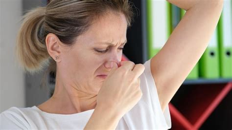 Premium Photo | Unhappy woman smells her armpit close up unpleasant smell under armpit and ...