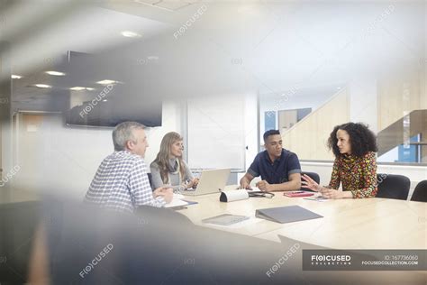 Business team meeting at conference table — 20 to 24 years, networking - Stock Photo | #167736060