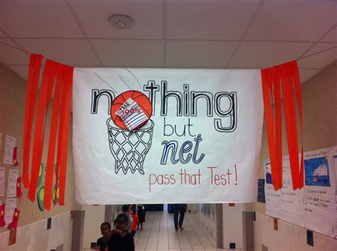 there is a sign that says nothing but net pass that test hanging from the ceiling