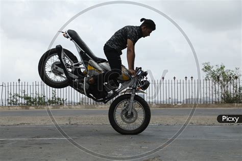 Image of Biker Performing Stunts on Bike-XB401665-Picxy