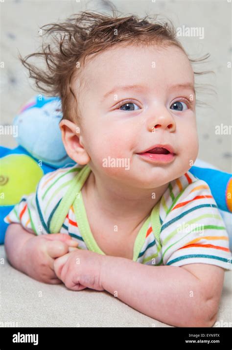 Portrait of an adorable smiling baby playing with a monkey toy Stock Photo - Alamy