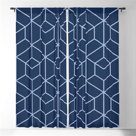 a blue and white curtain with an abstract geometric design on it, hanging in a room
