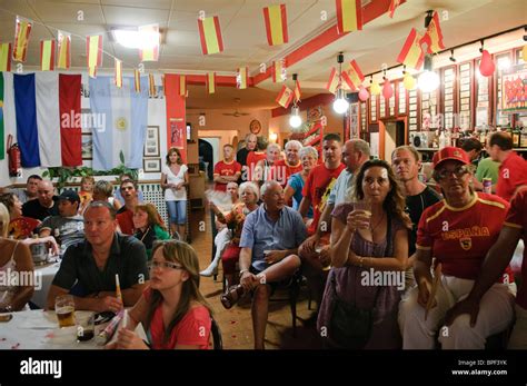 football fans watch the FIFA World Cup 2010 Final on large TV screens inside bar in Altea La ...