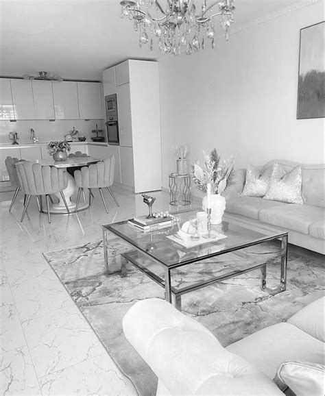 a black and white photo of a living room with couches, coffee table and ...