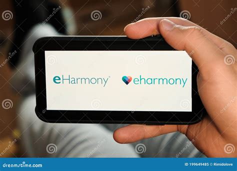 Eharmony Logo on the Screen of Mobile Phone in Mans Hand. Application for Dating and ...