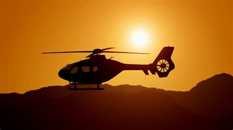 Aerial view of helicopter flying over mountains into the clouds during magical sunset in Los ...