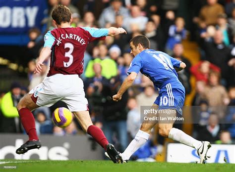 Joe Cole of Chelsea shoots past defender George McCartney of West Ham ...