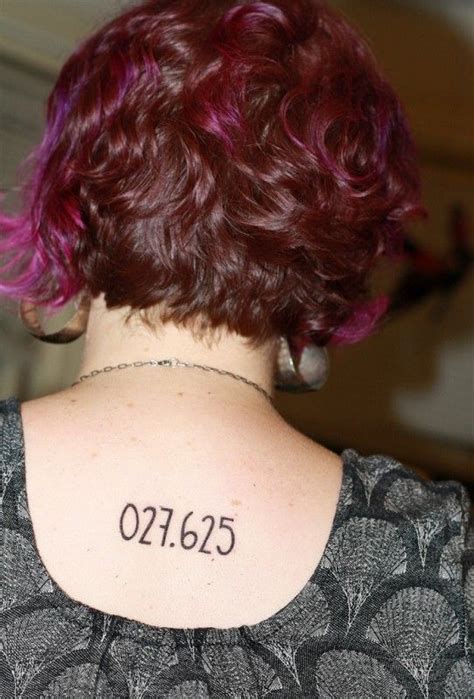 the back of a woman's neck has a tattoo on it that reads 02165