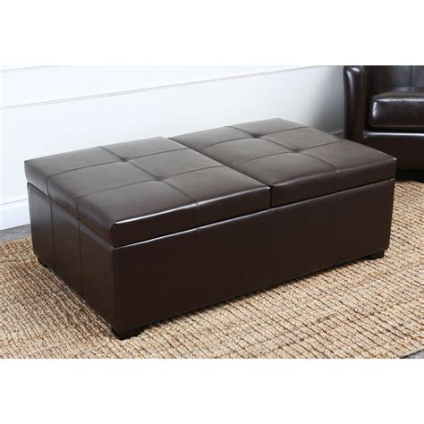 Combining function with style, this brown leather storage ottoman features a hardwood frame for ...