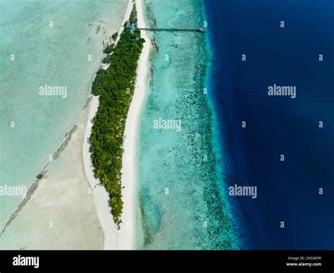 Top view of atoll and tropical island Mataking with beach. Tun Sakaran ...