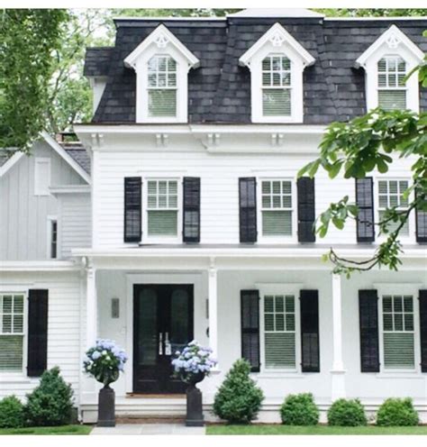 Cute simple cozy white house with black shutters, topiaries and sconces ...