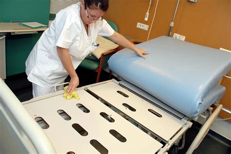 Nurse Cleaning Hospital Bed Photograph by Aj Photo/science Photo ...