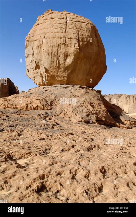 Eroded rock formation, round boulder balanced on a rock base in Tin Stock Photo: 17590277 - Alamy