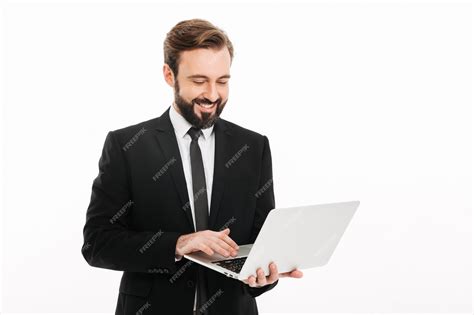 Premium Photo | Happy young businessman using laptop computer.