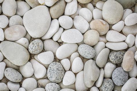 White pebbles background, simplicity, daylight, rounded stones. Natural bright pebbles stones ...