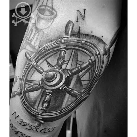 Amazing black and grey ship's wheel tattoo with coordinates by Kevin Soto. #12ozstudios # ...