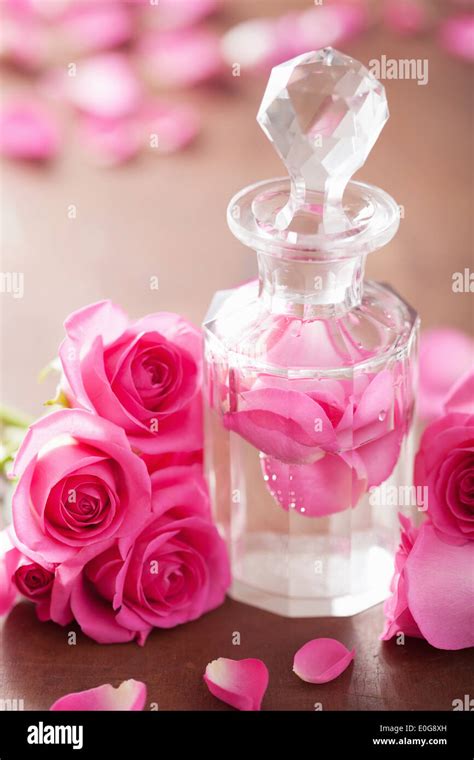 perfume bottle and pink rose flowers. spa aromatherapy Stock Photo - Alamy