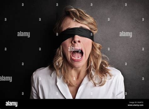 Scared woman blindfolded screaming Stock Photo - Alamy