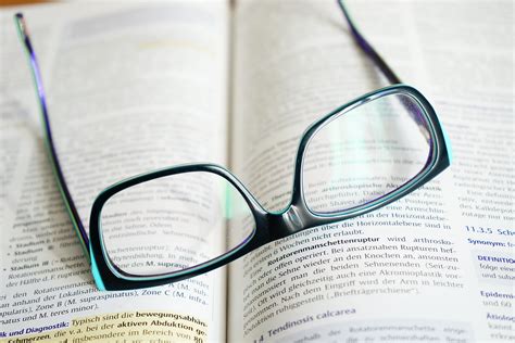 Eyeglasses With Black Frames on Book · Free Stock Photo