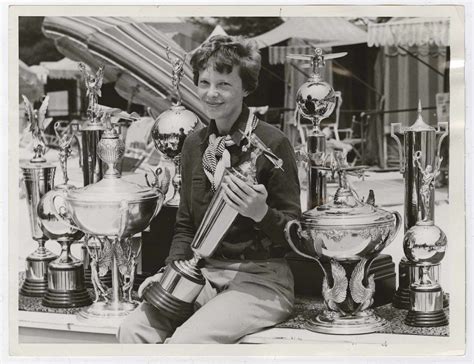 [Amelia Earhart surrounded by trophies] | International Center of ...