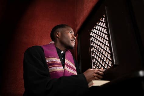 Free Photo | Young male priest inside the confessional booth at church