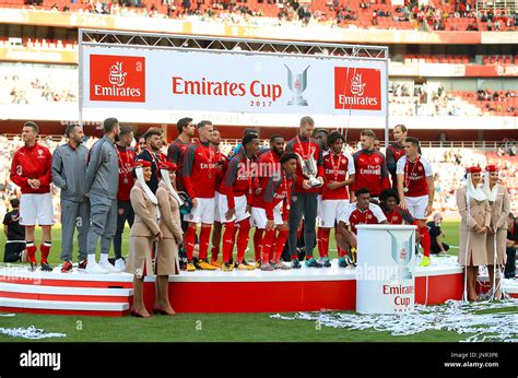 Arsenal players pose with the trophy after winning the Emirates Cup at the Emirates Stadium ...