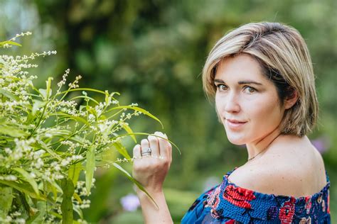 Beautiful woman standing in lush garden · Free Stock Photo