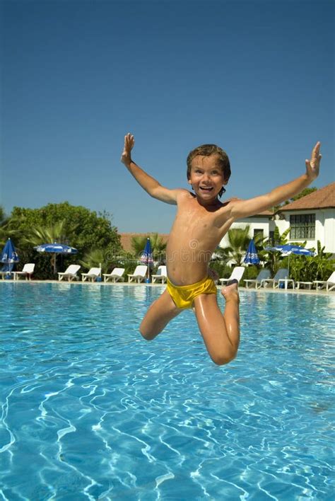 Boy jumping into the pool stock photo. Image of playful - 7076692