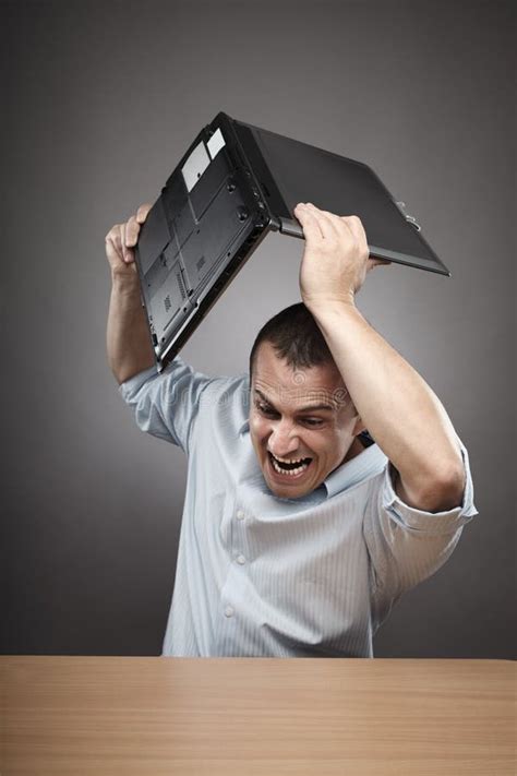 Angry Businessman Smashing His Laptop Royalty Free Stock Images - Image: 21042759