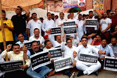 Congress party activists shout slogans and display placards during a ...