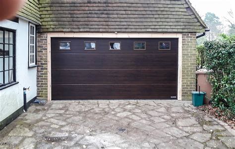 A Hormann LPU42 L-Ribbed Sectional Garage Door in Mahogany Woodgrain