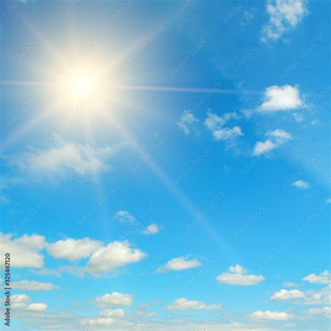 Bright midday sun in the blue sky. Stock 写真 | Adobe Stock