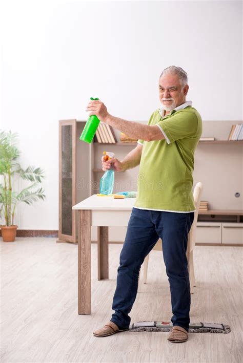 Old man cleaning the house stock image. Image of dusty - 235071945