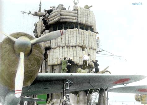 Crewmen aboard the IJN Akagi lash futon mattresses to the carrier's ...