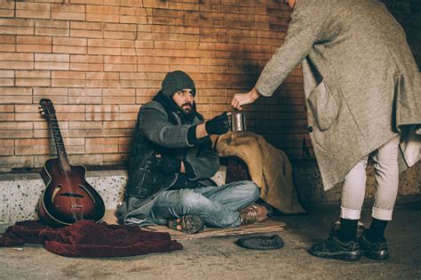 Giving Money To Homeless Man Stock Photo - Download Image Now - iStock