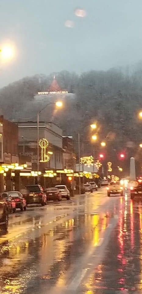 Downtown Elizabethton, TN - Christmas decorations in the background also holds 3 white crosses ...