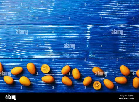Light blue flat lay with top view on fresh ripe kumquat citrus fruits Stock Photo - Alamy