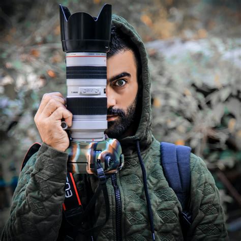 Person Holding a Dslr Camera · Free Stock Photo