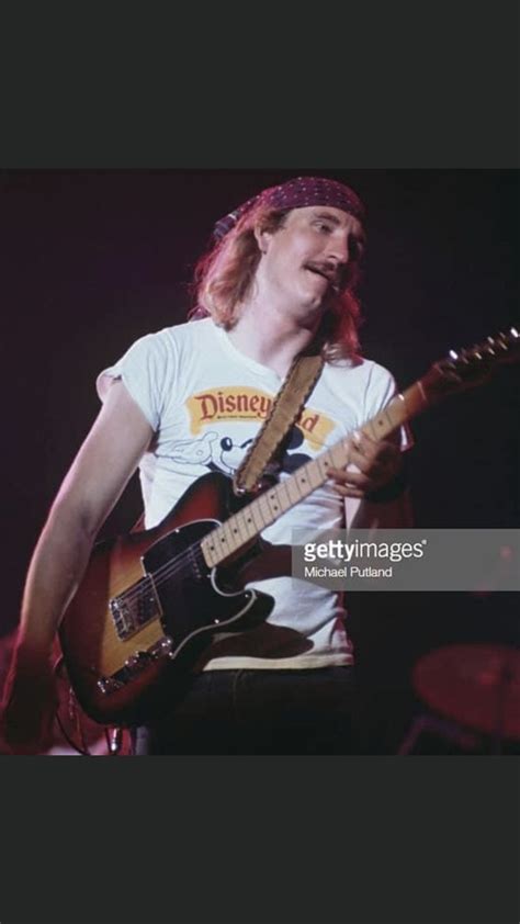 a man playing an electric guitar on stage